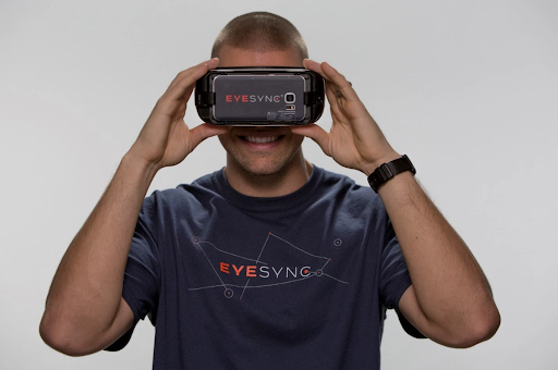 Photographic Representation of Mixed Reality, man wearing EyeSync VR (Virtual Reality) headset which is used to test for concussions in athletes.