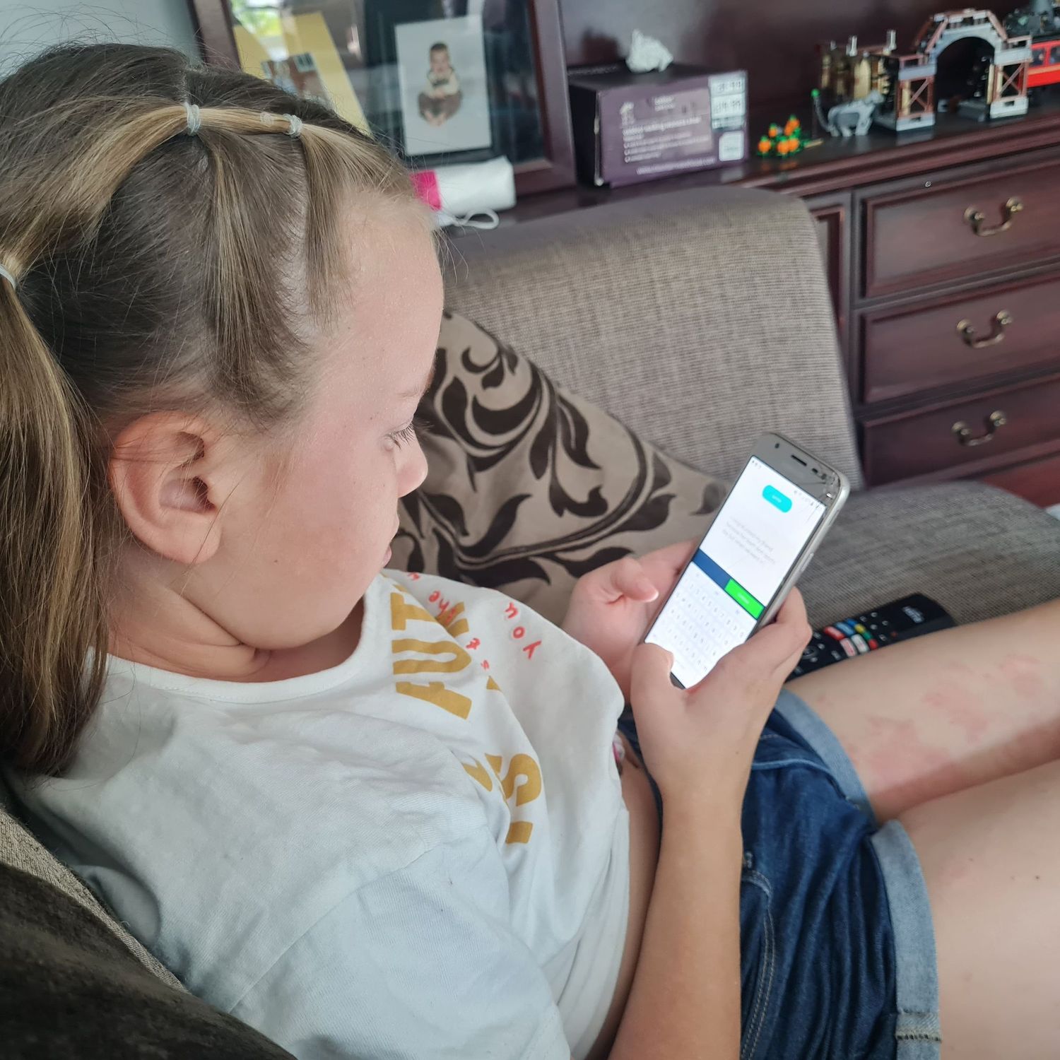 A child working on Bedrock on her phone