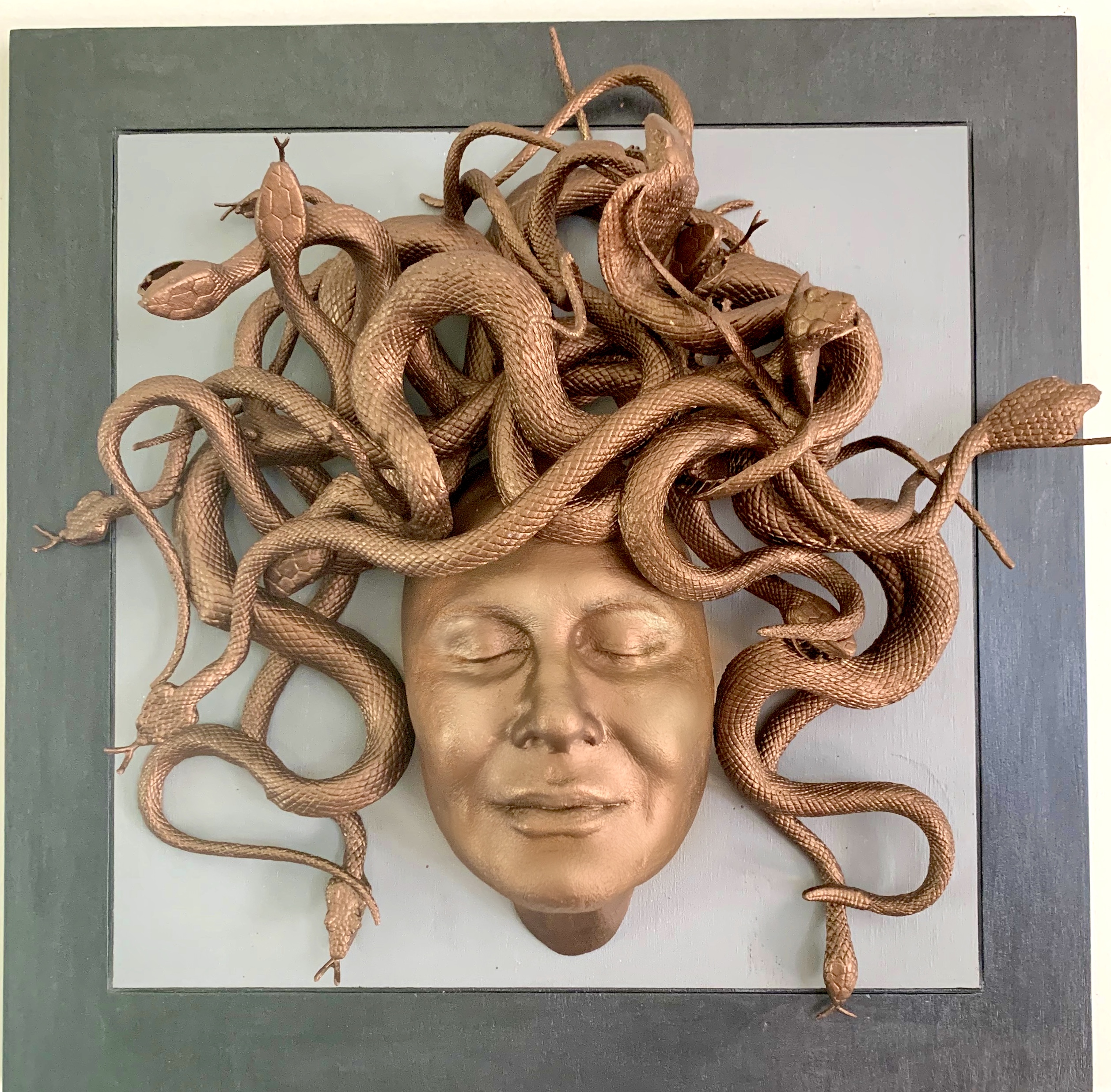 Sculpture of face with snakes for hair