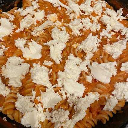 **Preheat the oven to 375°**. Remove thyme sprigs if you added them before. Mix together simmered tomato sauce, **1/2 cup cream**, and cooked pasta. Dump into a 12" round or equivalent sized baking dish. Sprinkle **8 ounces mozzarella** over the top. Finish with grated parm.