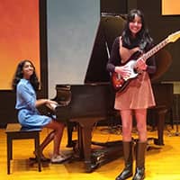 girls playing piano and guitar