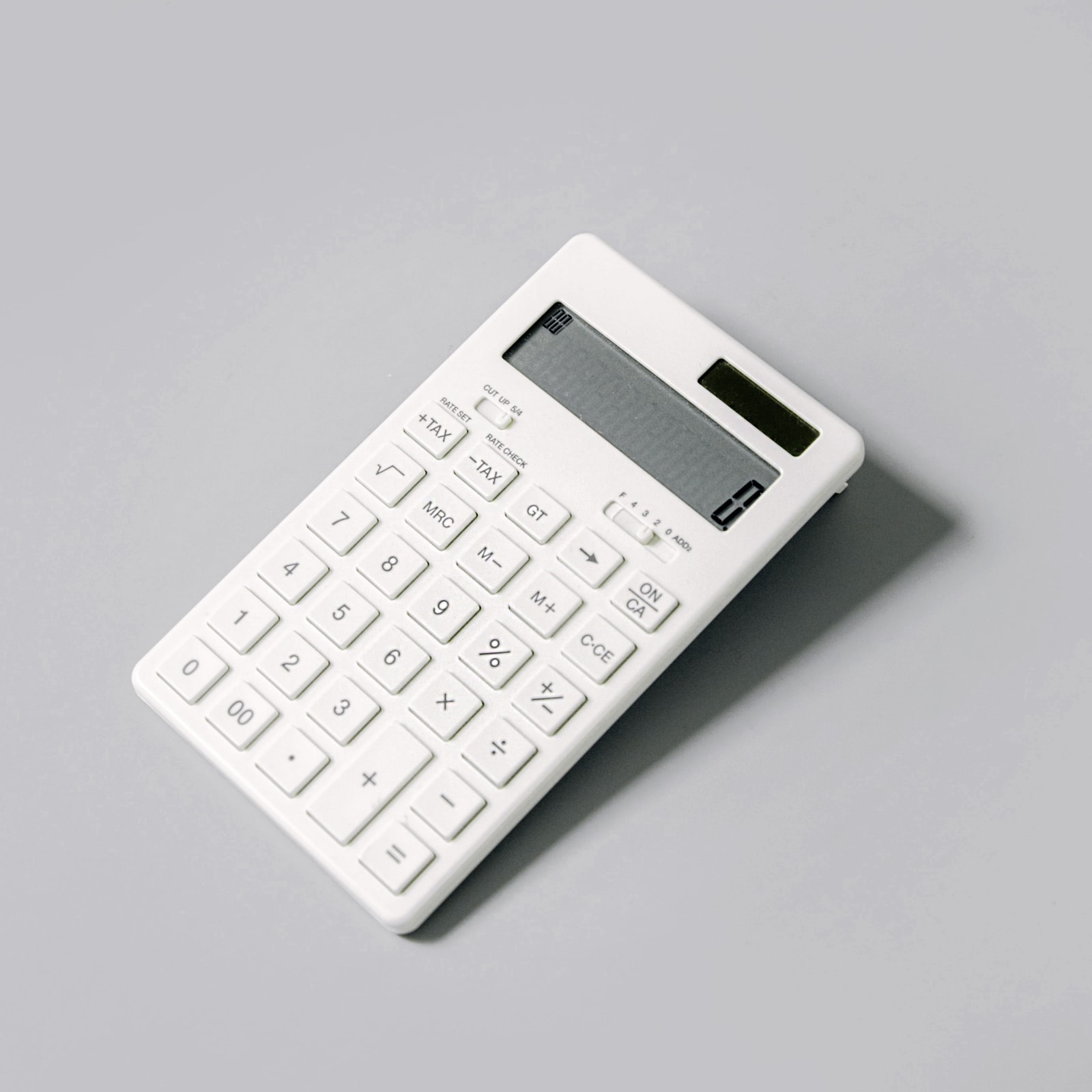 White calculator on gray background.