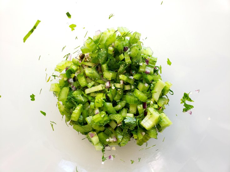 Bowl of sliced celery, red onion, and spices