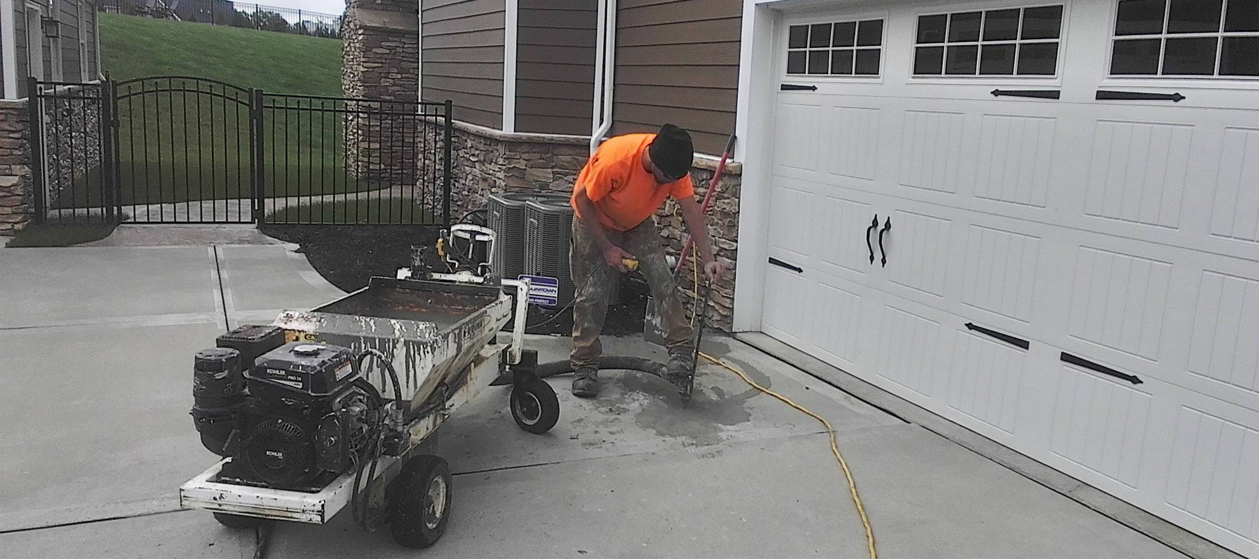 Man Repairing an Uneven Driveway with Mudjacking