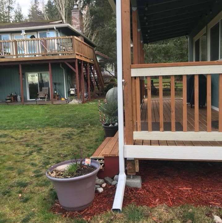 different angle of new gutter installation on green home