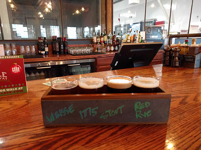 A flight of craft beer - stout, weisse, and ale