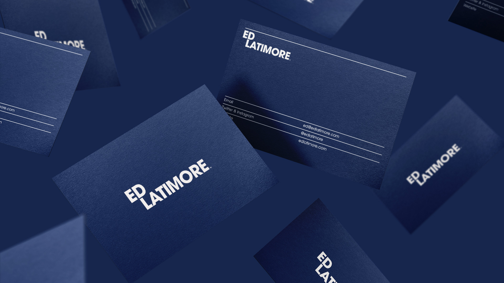 Multiple business cards bearing Ed Latimore's contact information, falling in the air