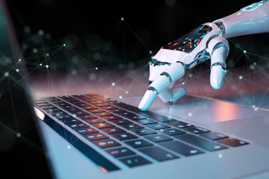 Robot hand controlling a laptop