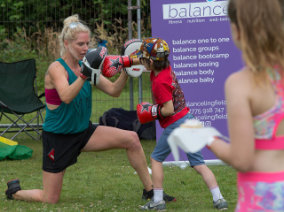 Lingfest 2019 Boxercise instructor takes punches from child ©Brett Butler
