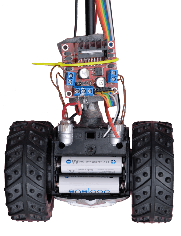 A L298N H bridge (for Arduino) power board drives the two DC motors of a modified FlyWheels toy. Four AA batteries powers the pendulum.