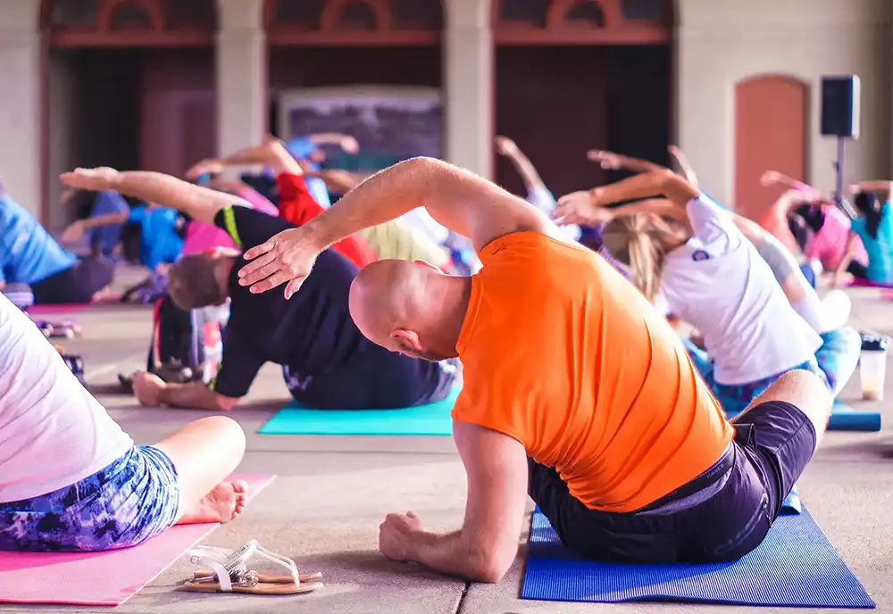 Yoga class with men and women stretching