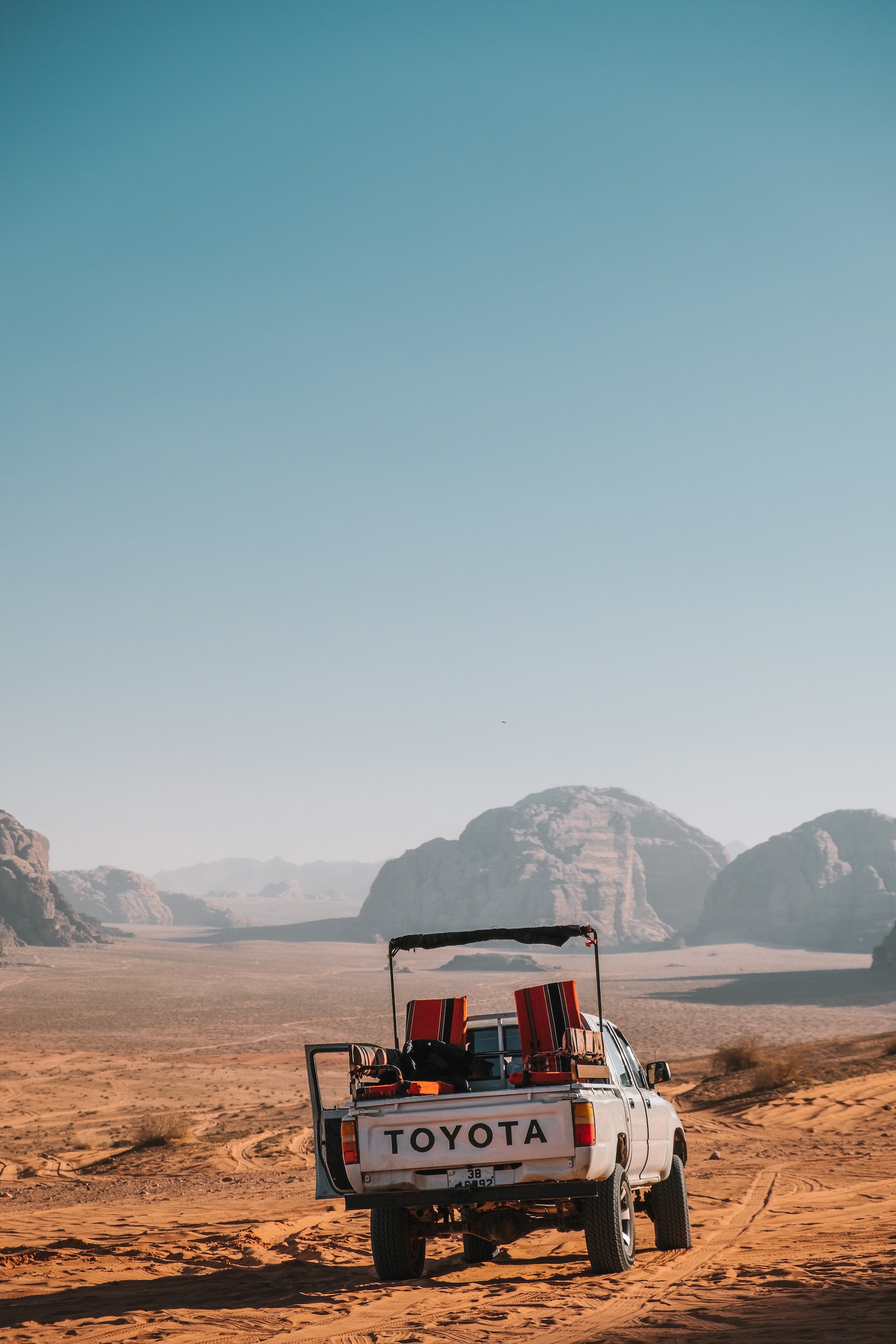 A Toyota truck driving through a barren landscape.