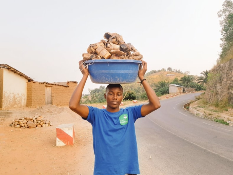 Photo: Founder of Greening Burundi Emmanuel Niyoyabikoze carrying biodegradable seedling bags