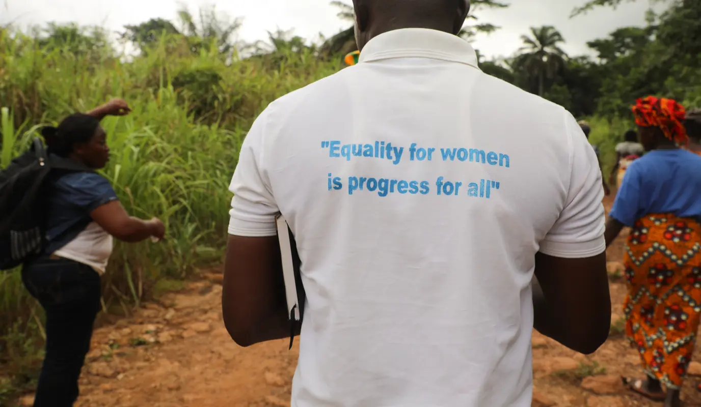 A man in Sierra Leone wears a gender quality t-shirt
