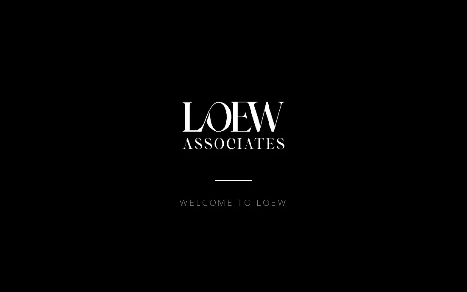 Loew Associates homepage screenshot showing custom interior design website with branded logo transitions