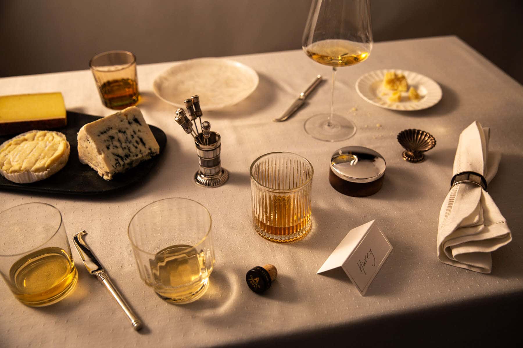 selection of cheese and whiskeys on a table party vibe