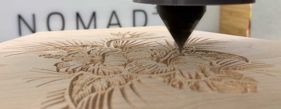 Wood being v-carved on a Nomad Desktop CNC