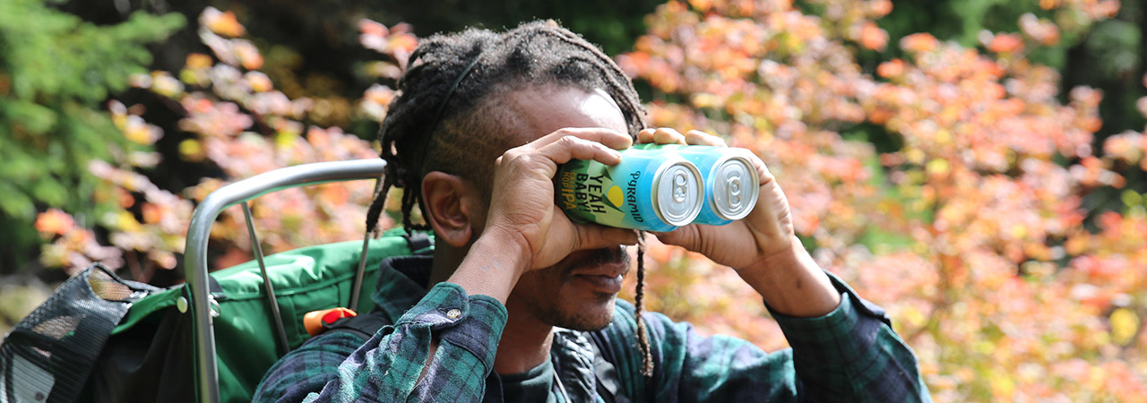 Dude using Yeah Baby! cans like binoculars