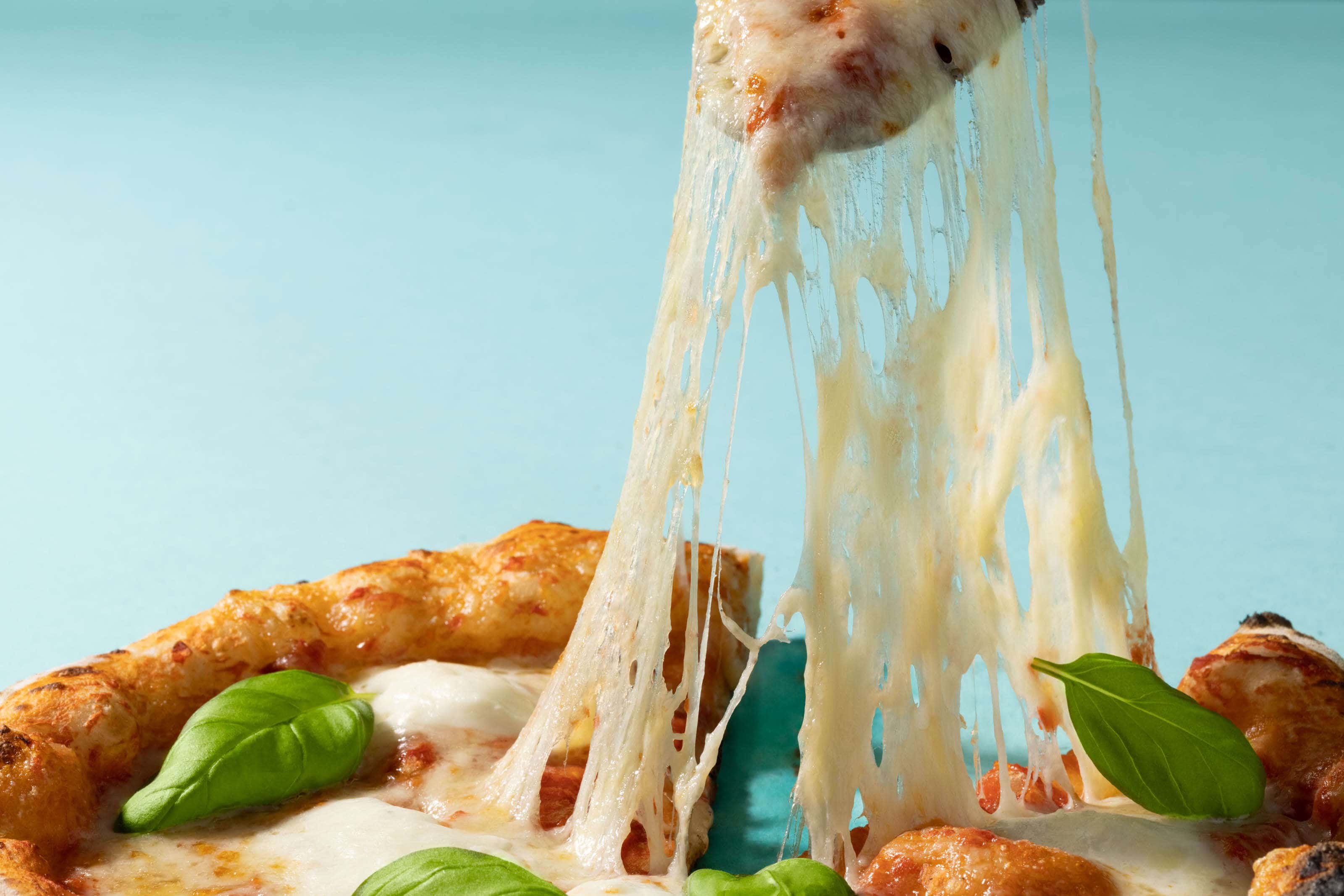 pizza with stringy delicious cheese and basil
