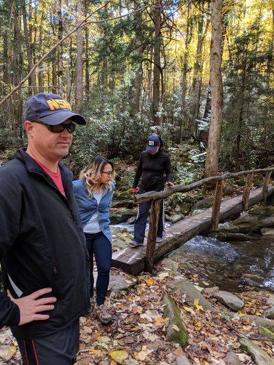 Märt Matsoo, Kim Sarabia, and Clare Ming cross a stream in the Smoky Mountains.