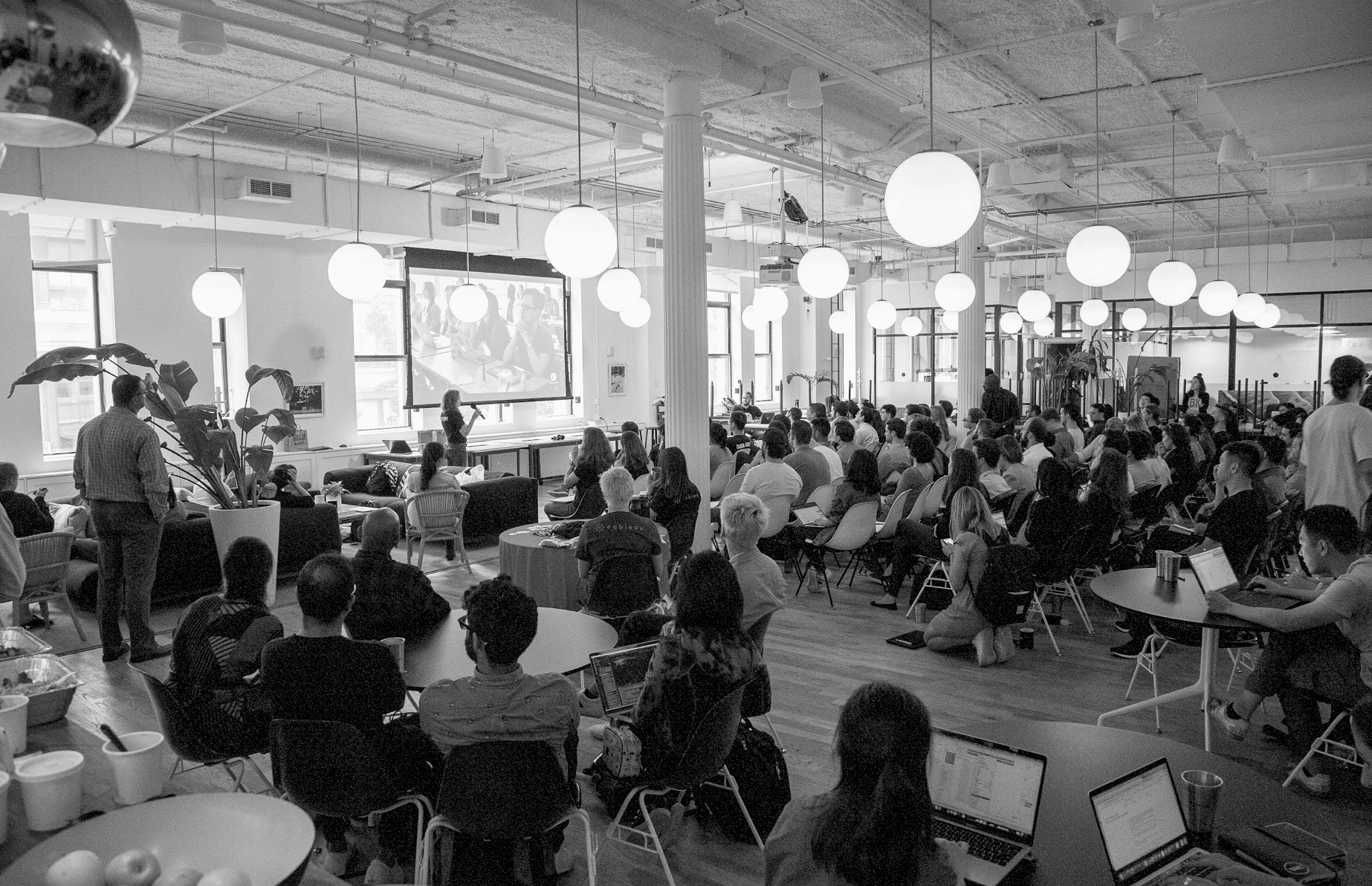 seated crowd listening to a Data Culture presentation, black and white