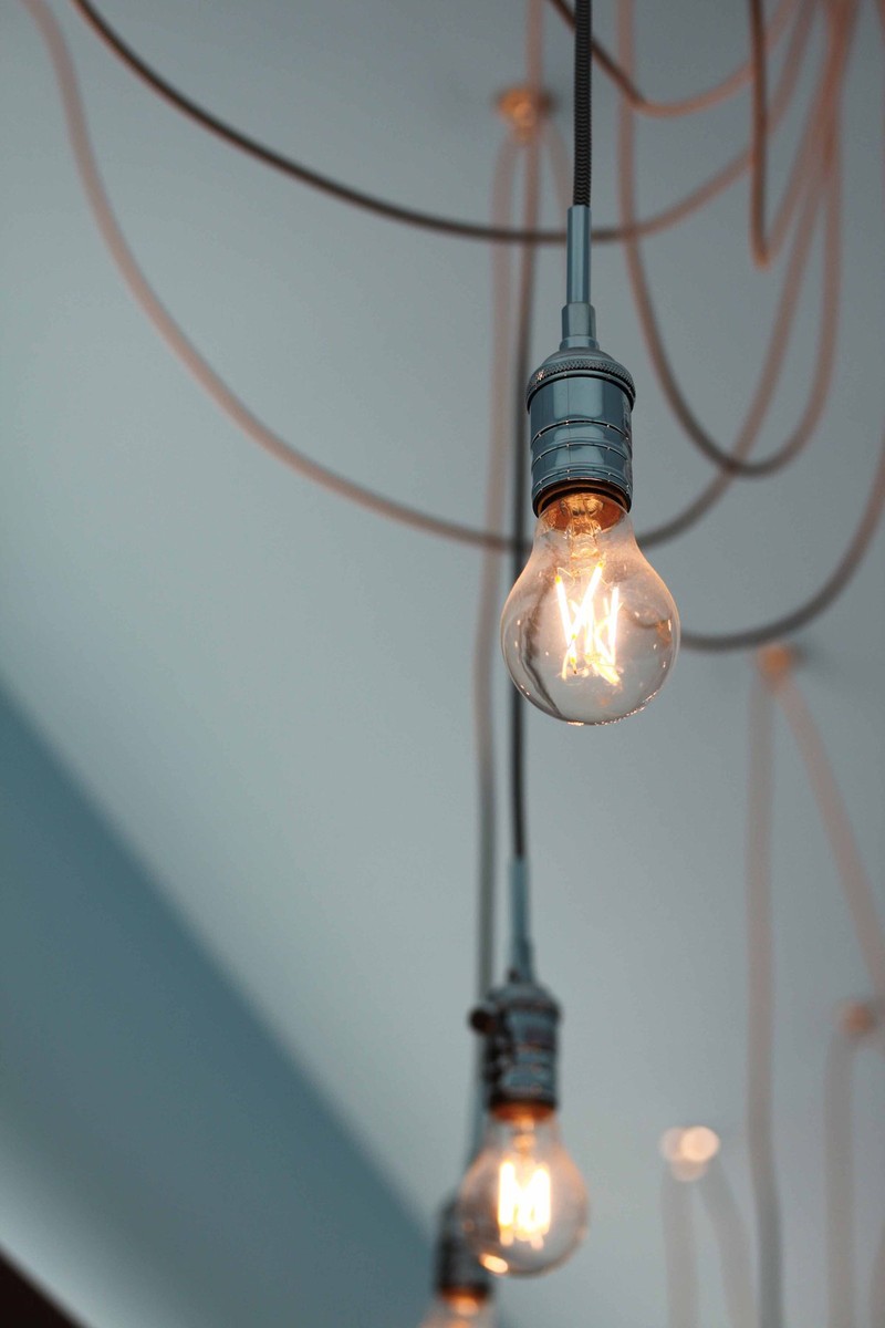 Light bulbs hang from ceiling wires