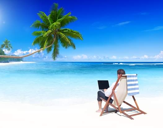 Working remotely from a beach while on holiday Working remotely from a beach while on holiday