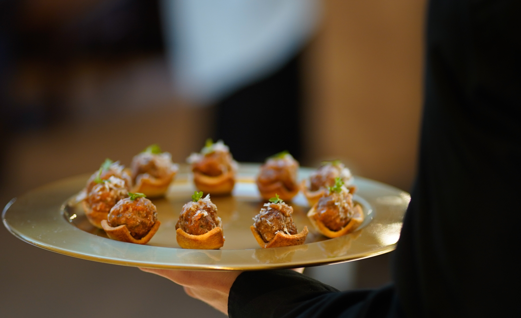 A caterer passing hors d oeuvres