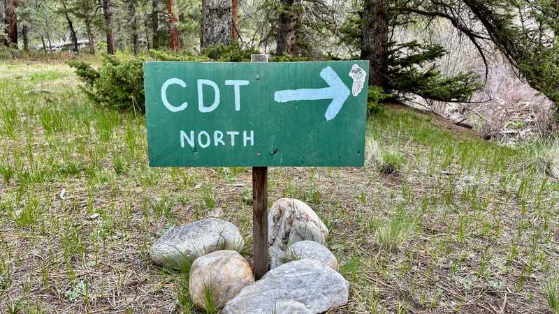A sign points the direction for CDT northbound hikers to follow