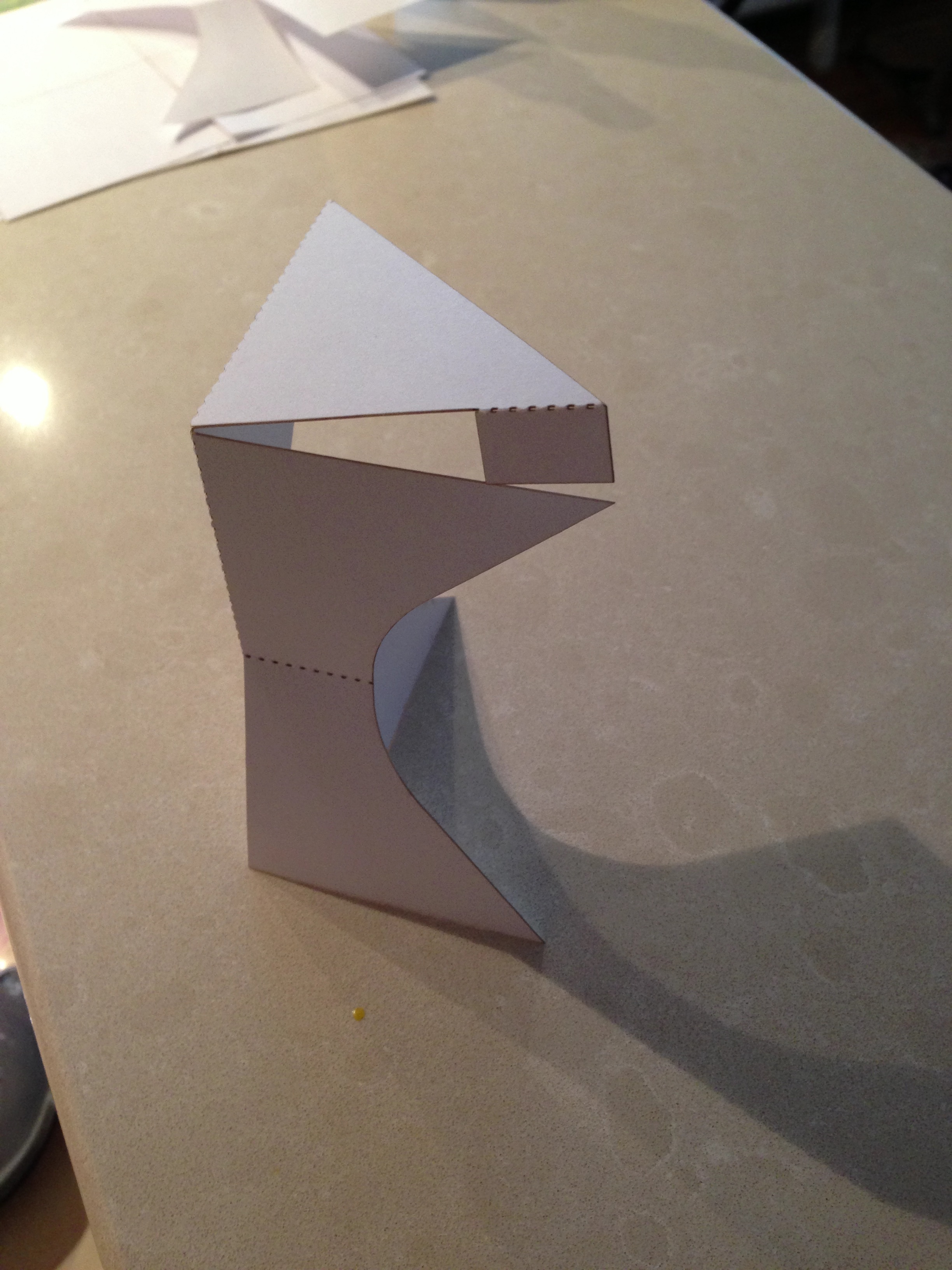 a tiny laser-cut paper model for a lectern. We used its folds to imagine how the piece would fit together without hardware.