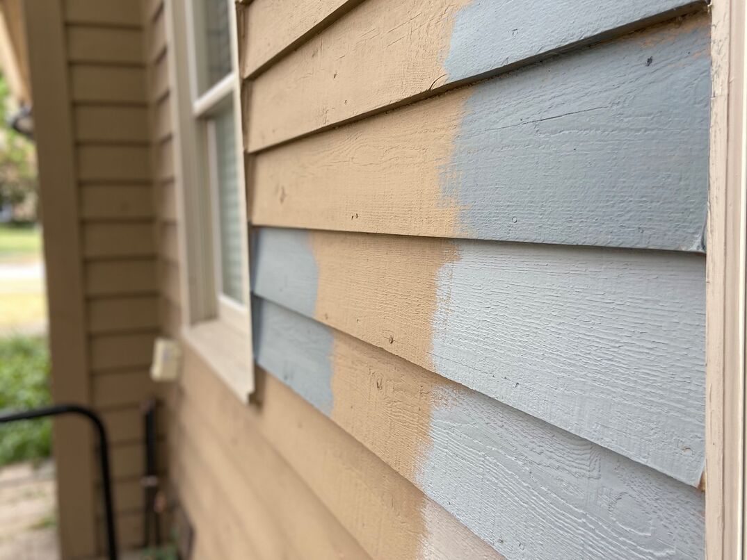 close up of cedar siding with multiple paint samples on it