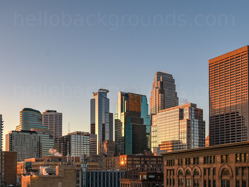 Urban cityscape at dawn featuring many office buildings of various designs featuring many windows   Microsoft Teams background