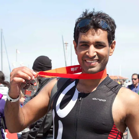 Photo of Kunal holding a race medal