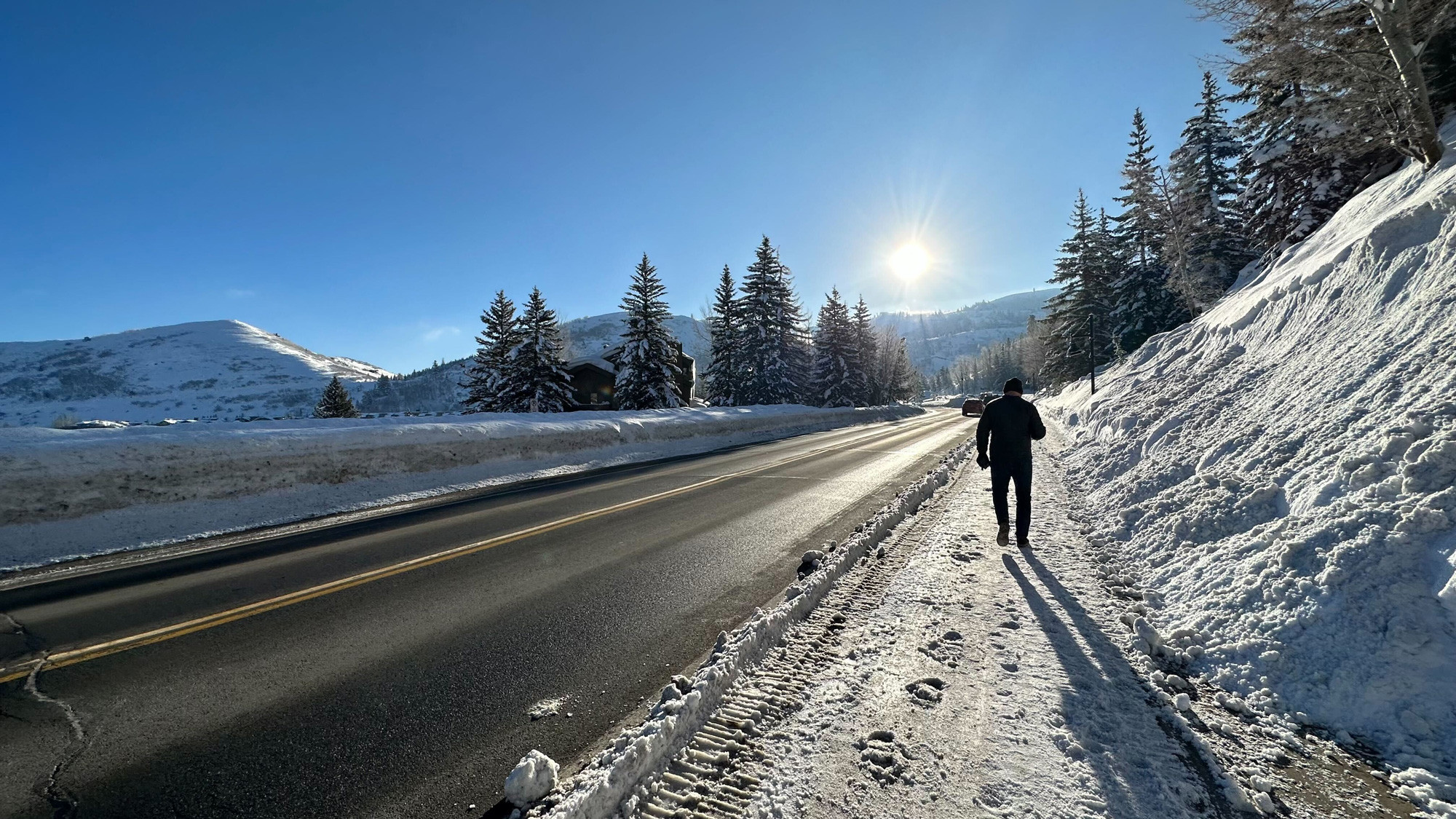 A person walking down a snow-covered road