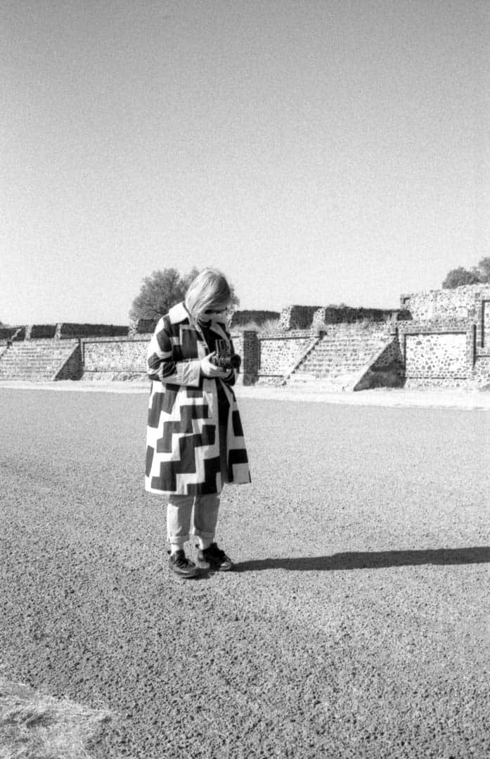 A woman takes a photograph at Teotihuacan pyramid