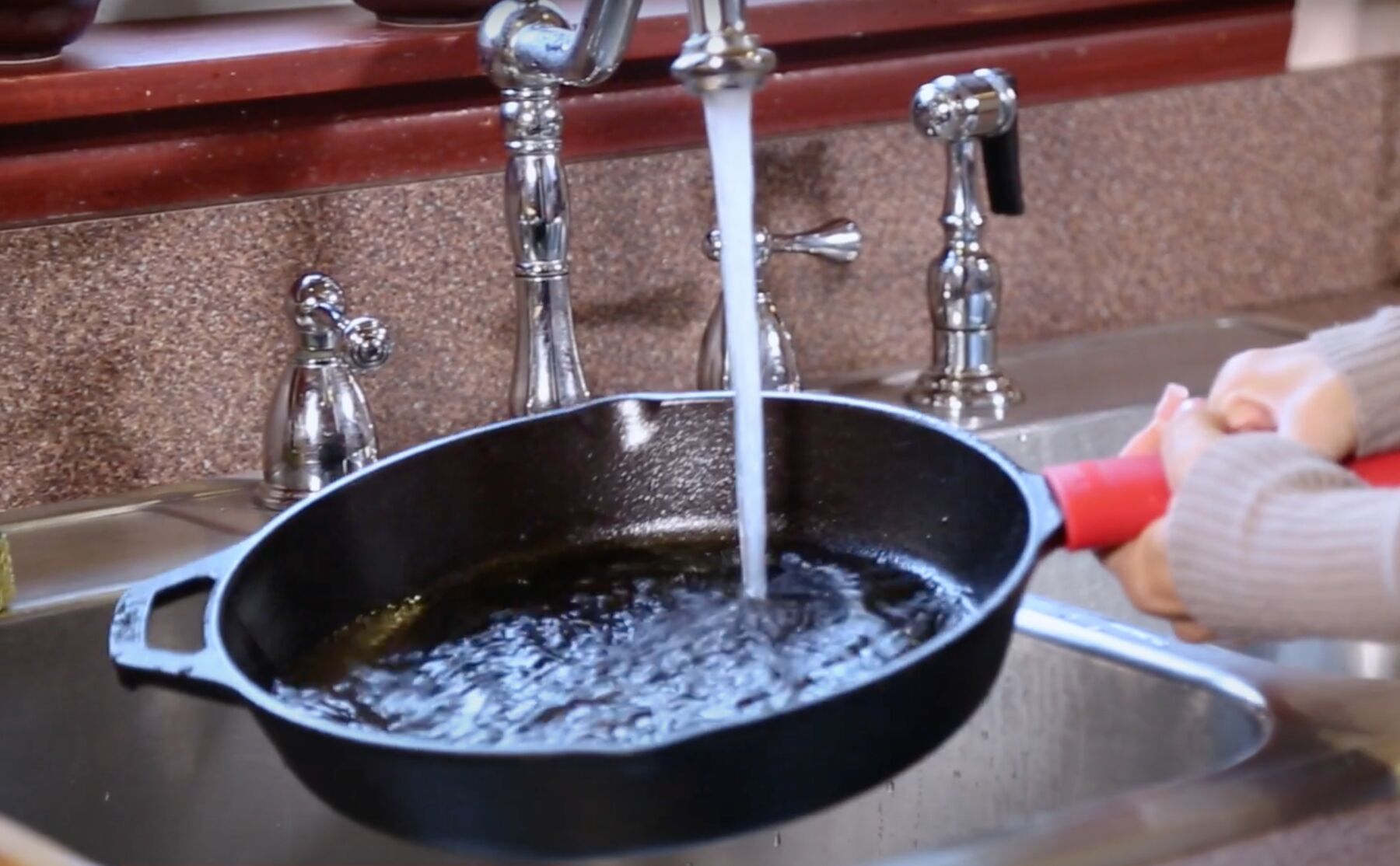 cleaning cast iron skillet in kitchen sink
