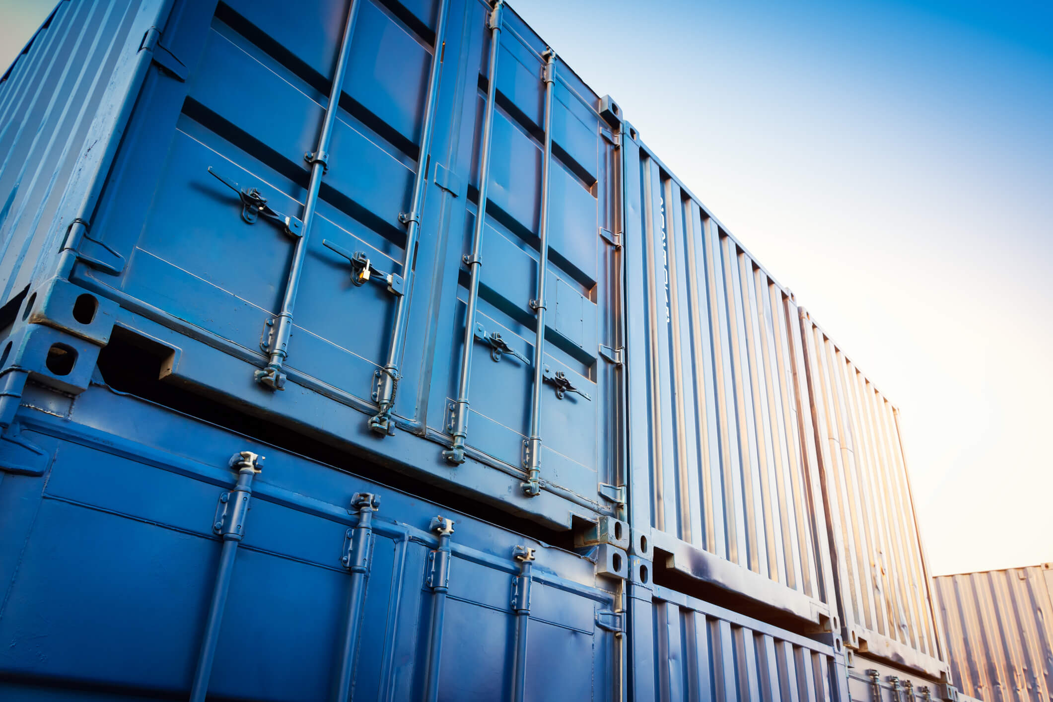 Storage containers stacked on-top of eachother in the yard.