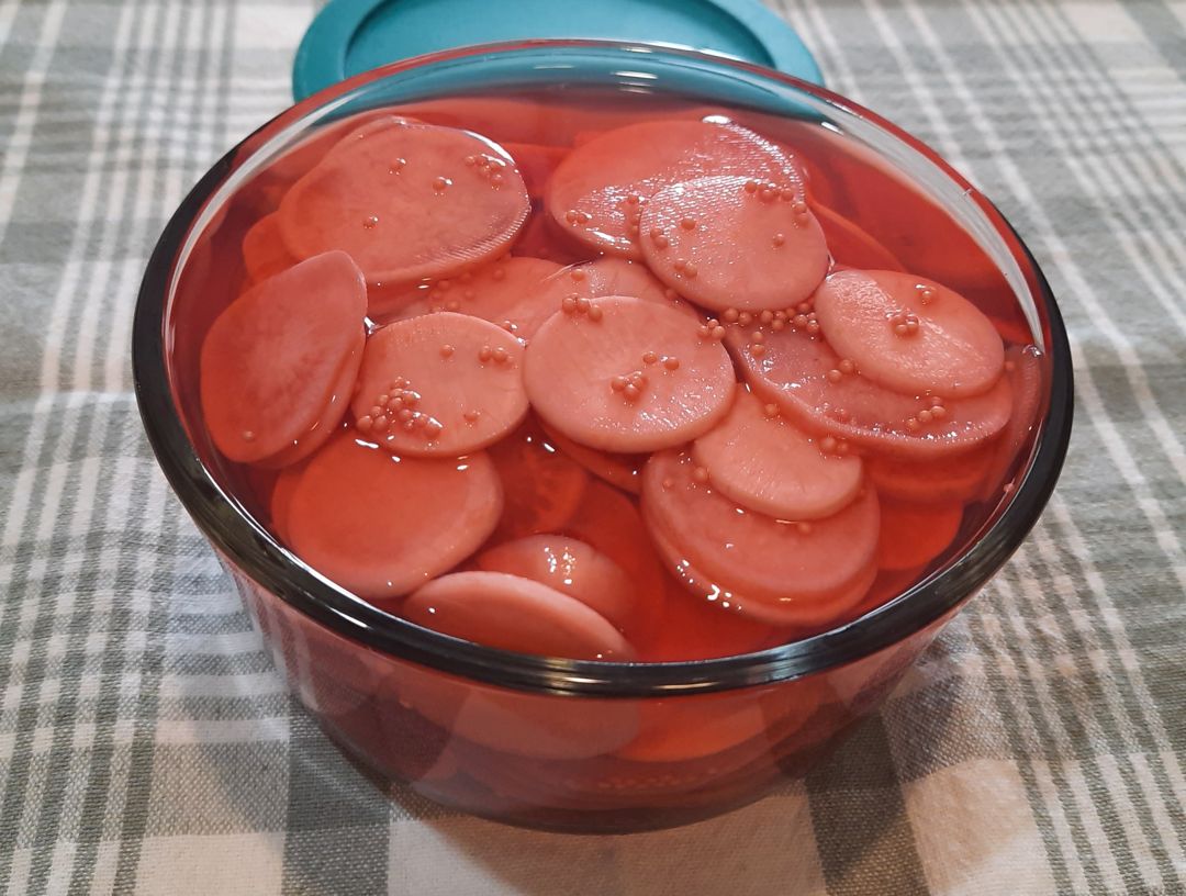Pickled radishes in a glass container