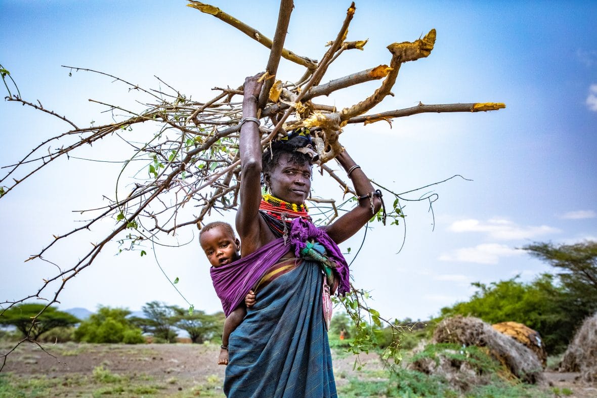 Woman with baby collecting firewood