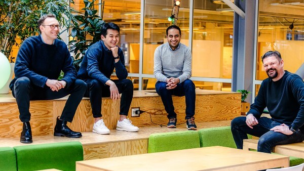 Merkely team smiling and sitting on benches