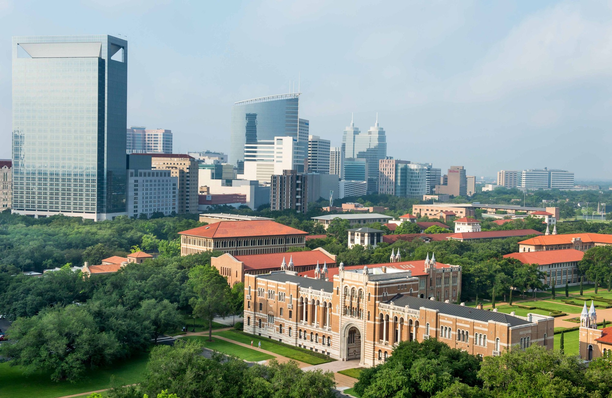 Aerial view of Rice University's Lovett Hall with tall buildings in the background