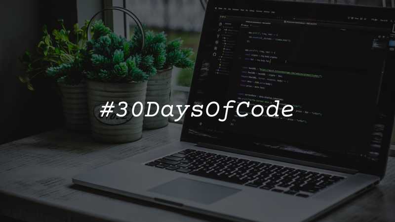 Turned-on gray laptop computer with overly text "30 Days of Code"