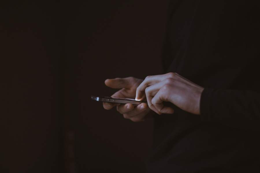 Person using their phone to search for IT services in San Marcos TX