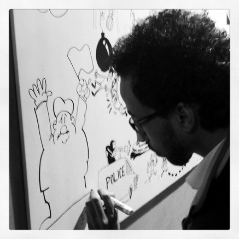 Anwar participates in a cartoon anti-government draw-off in a downtown Cairo square, January 2013. Photo by the author