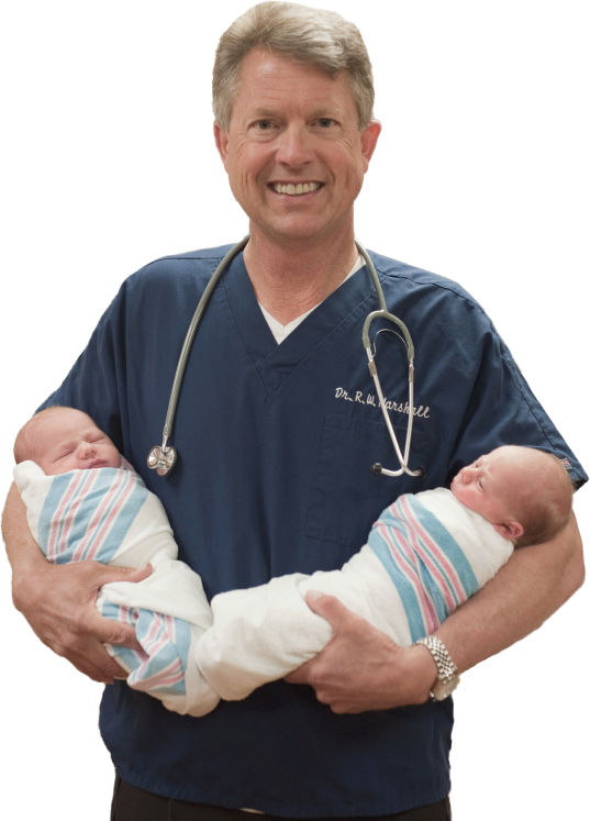 Dr. Roger Marshall holding two newborn babies