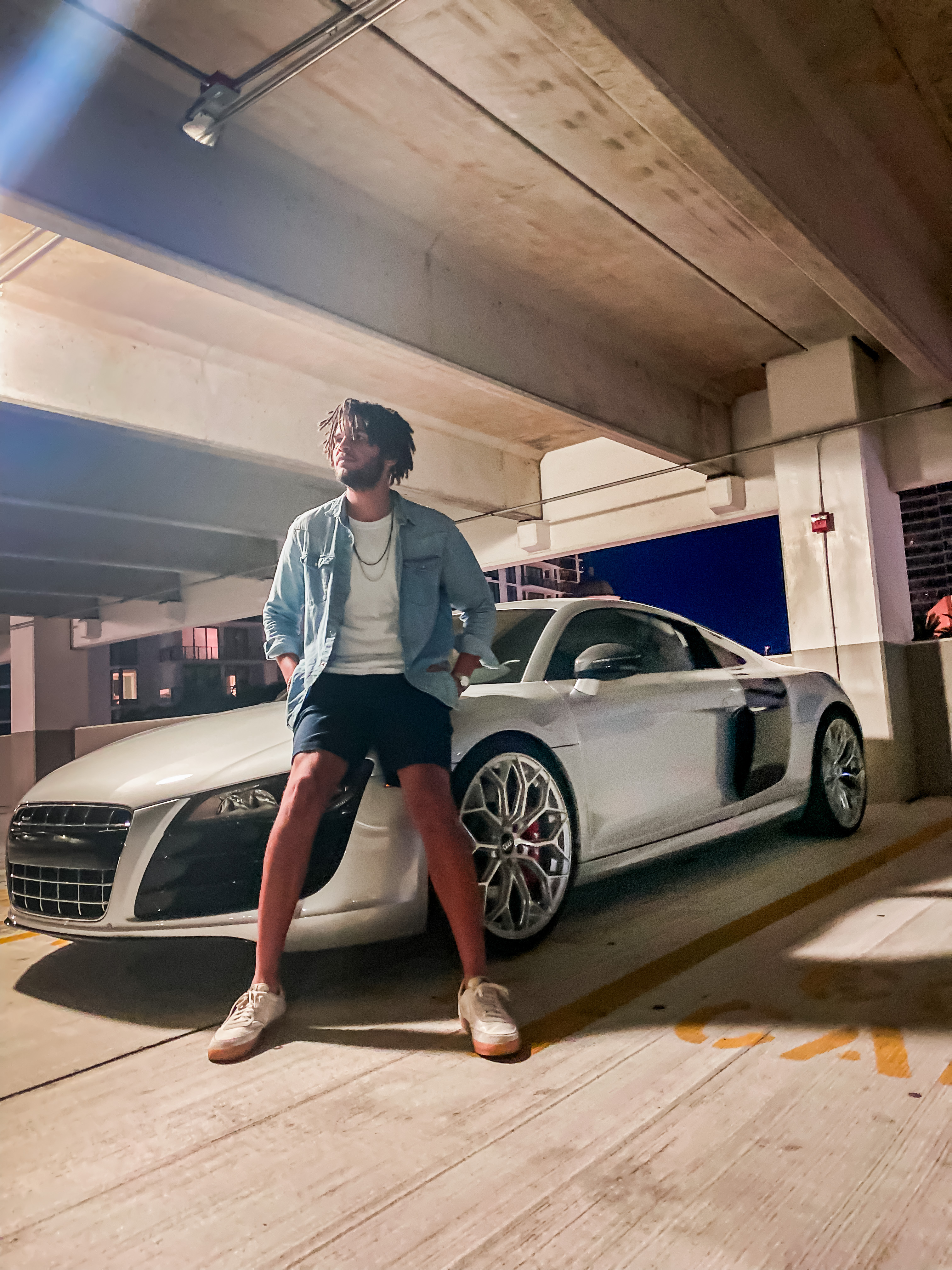 Alex with Audi R8 in a parking garage