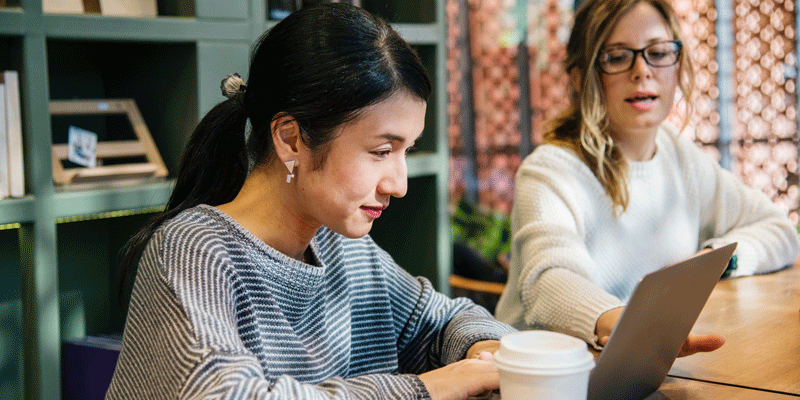 Two designers creating microcopy as part of the UX design process Two designers composing microcopy, a crucial part of the UX design process