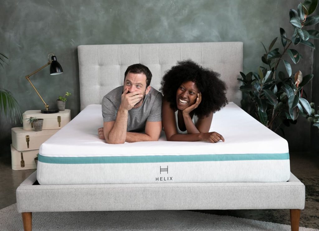 couple laying on Helix Midnight mattress