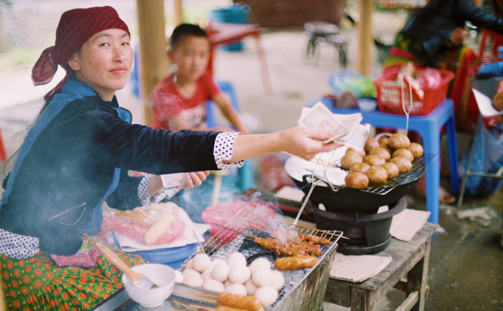 woman selling rice balls by the roadside
