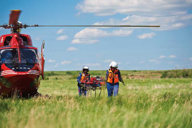 Stars helicopter paramedics carry a stretcher from their helicopter Stars helicopter paramedics carry a stretcher from their helicopter